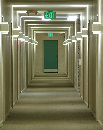 Illuminated egress corridor with exit sign