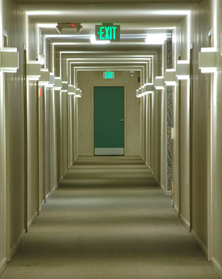 Illuminated egress corridor with exit sign