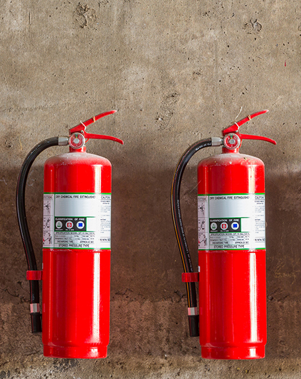 Commercial fire extinguishers mounted at a client location